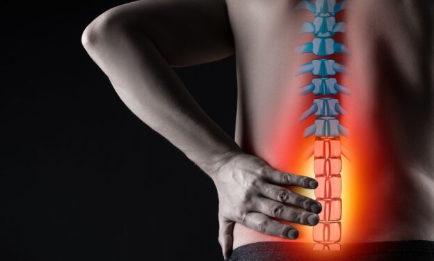 Photo of a man's body on black background, painful area highlighted in red - concept of chronic back pain